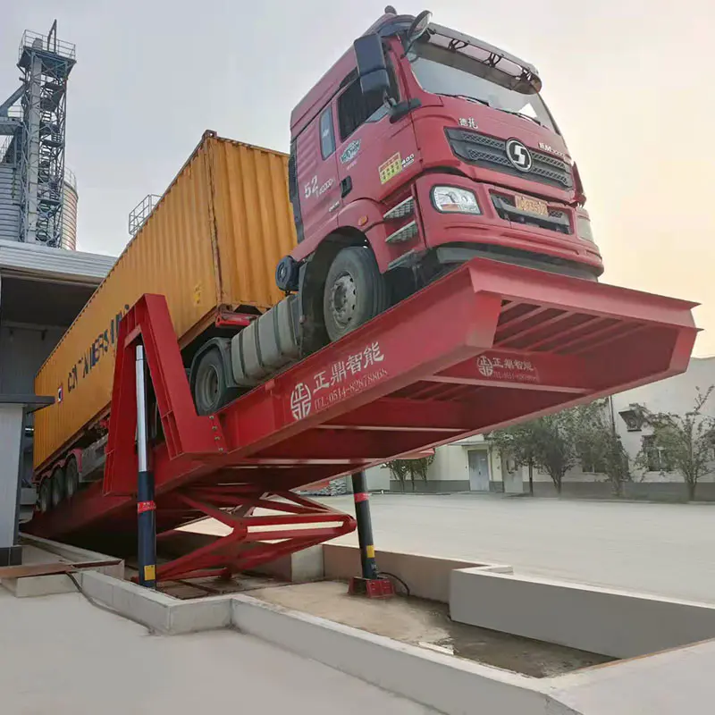 Shallow foundation truck dumper in operation, lifting a loaded container trailer for unloading